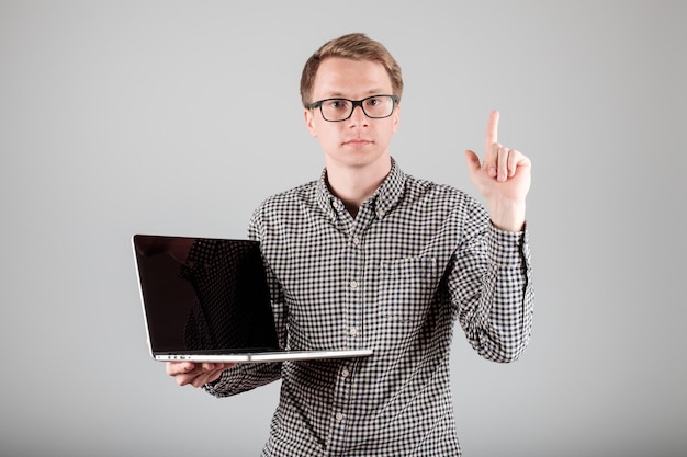Man presenting something on blank laptop screen