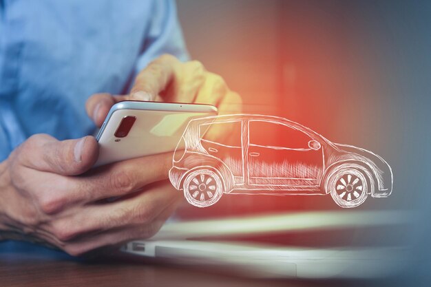 A man presses on the phone on a drawn car