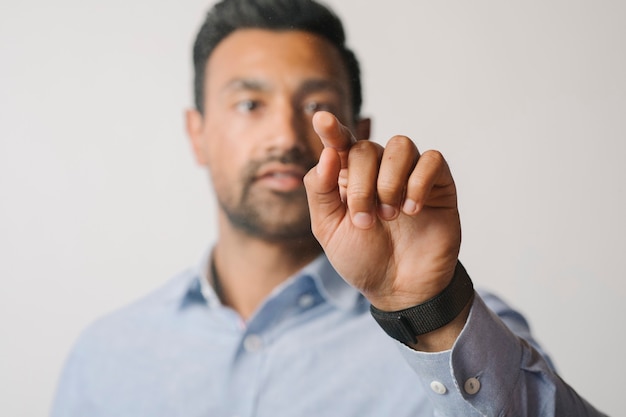 Man pressing his finger to a screen