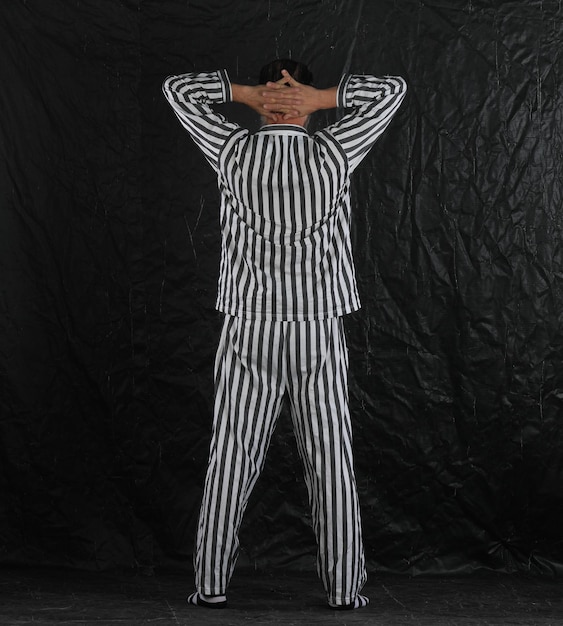 man in prison striped clothes