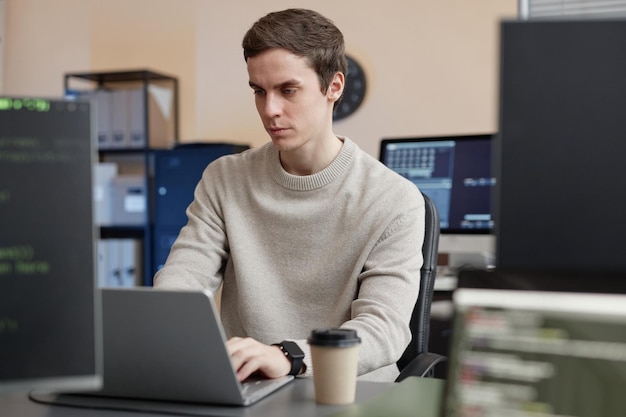 Photo man programmer using laptop