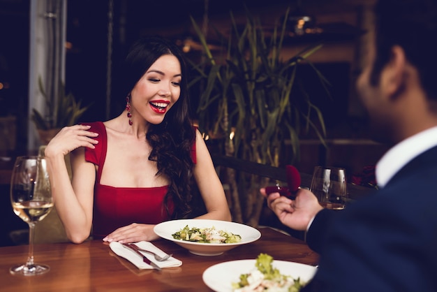 A man proposes to a woman and gives her a ring.