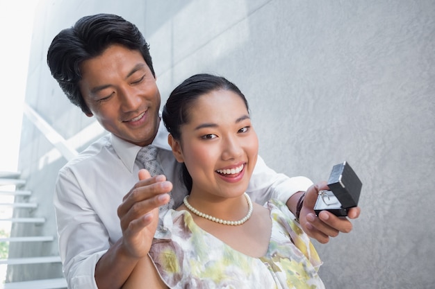 Man proposing marriage to his shocked girlfriend