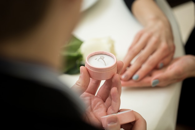 Man proposing with a diamond ring at the restaurant