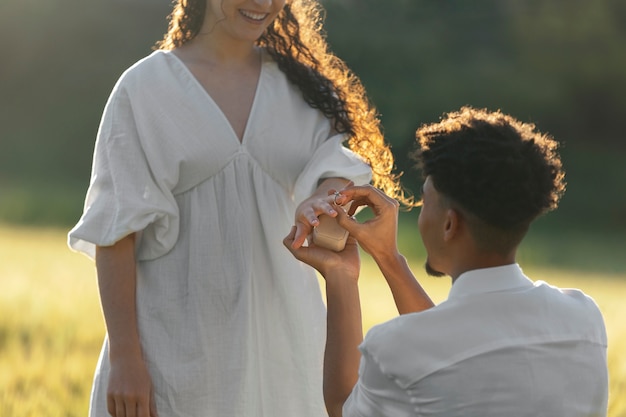 Man proposing with ring side view