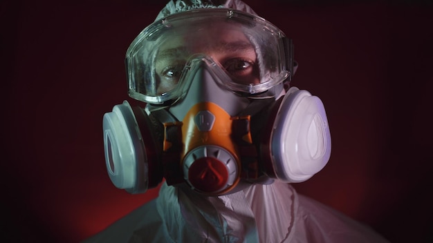 Man in protective costume suit gas protect medical antibacterial antiviral spray paint mask Doctor health worker in respirator Concept health virus coronavirus epidemic Radiation Nuclear war