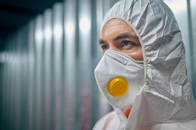 Man in the protective gear staring into the distance