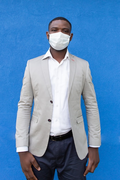 The man in a protective mask on a blue wall