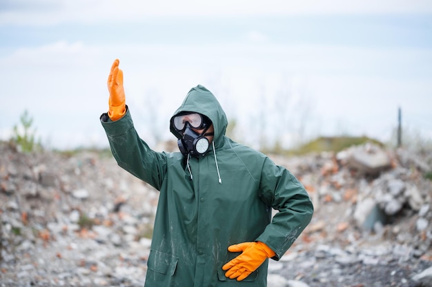 A man in a protective mask and protective clothing explores the danger zone Ecological catastrophe selective focus