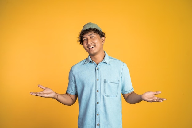 Man proud of himself looking at camera over yellow background