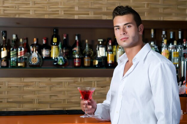 Man in a pub with red martini