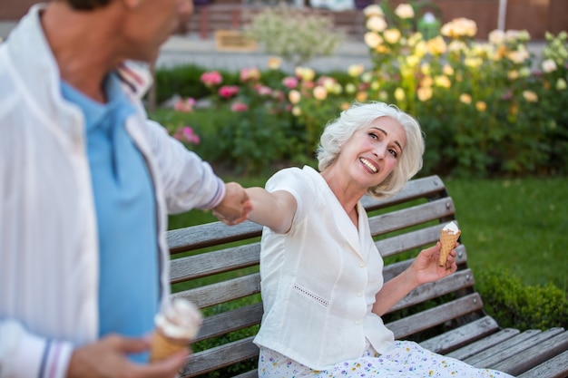 Man pulls mature woman's hand.