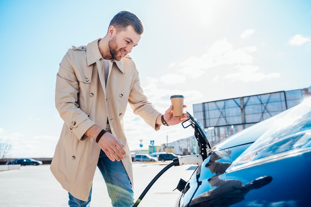 Man pulls out the car charging plug from the socket