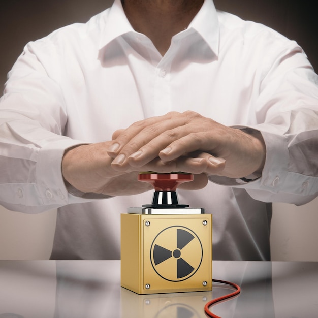 Человек нажимает кнопку ядерной бомбы Концепция ядерной войны Составное изображение между фотографией руки и трехмерным фоном