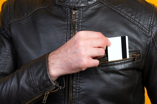 Photo a man puts a bank card in his breast pocket