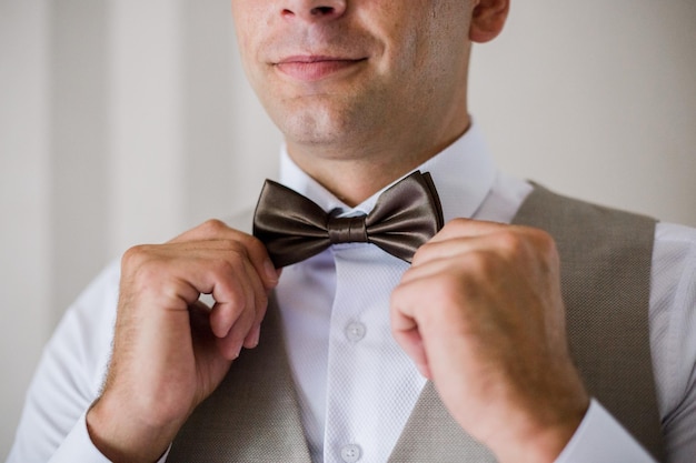 Man puts on a bow-tie