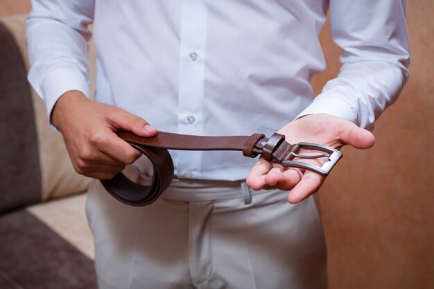 A man puts on a men's suit on the day of the wedding