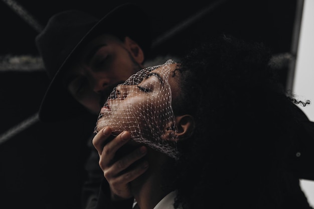 Man puts a net on face young african american woman with curly hair