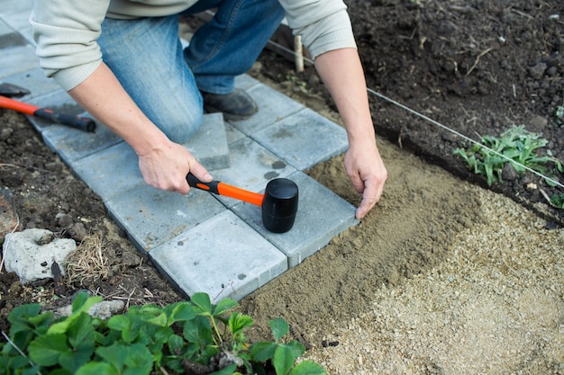 Man puts paving in the garden