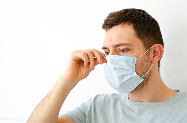 A man puts on a protective mask