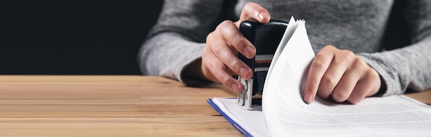 The man puts a seal on the document