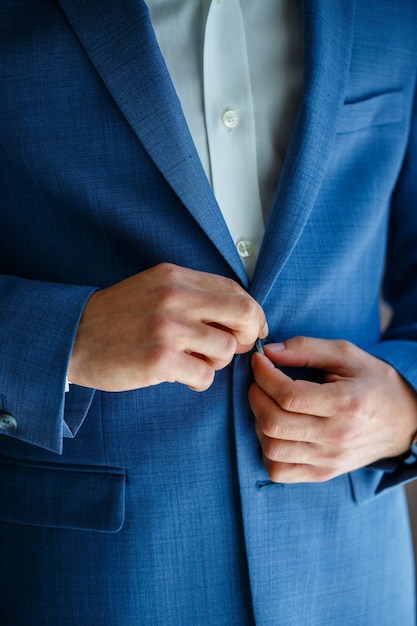 Man puts on a suit on the wedding day