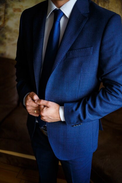 Man puts on a suit on the wedding day