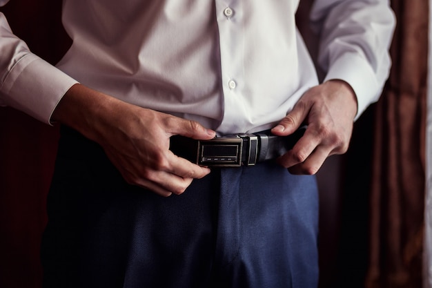 Man putting on a belt, Businessman, Politician, man's style, male hands closeup, American businessman, European businessman, a businessman from Asia, People, business, fashion and clothing concept