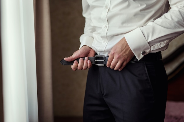 Man putting on a belt, Businessman,