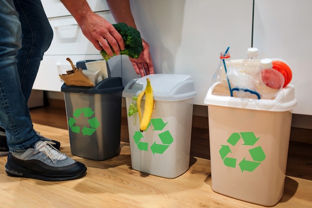 Man putting broccoli in the garbage bin