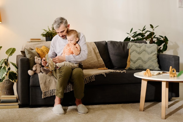 Man putting cross shoes on baby feet