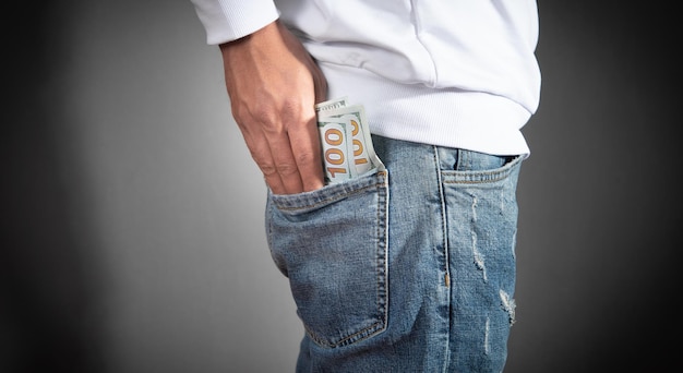 Man putting dollar into the pocket