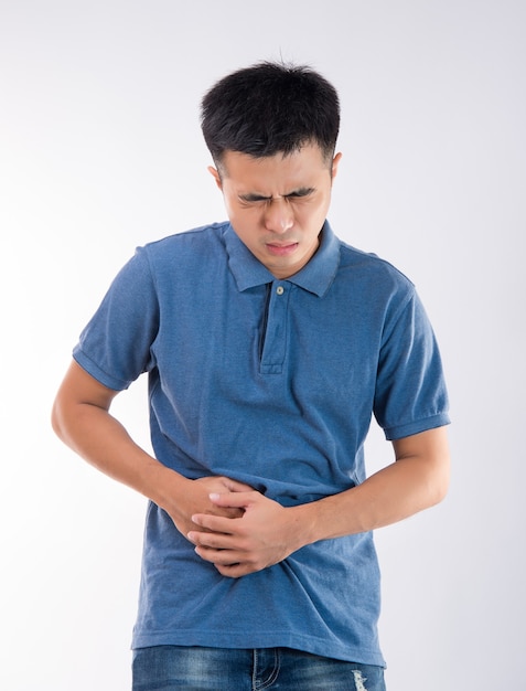 Man putting his hands on belly concept of stomachache on white background