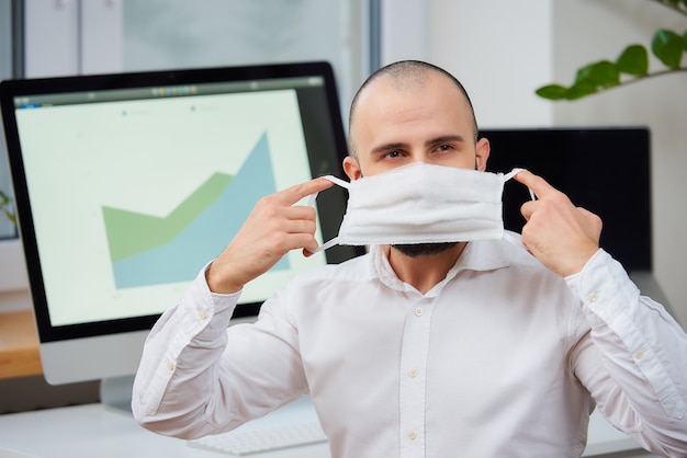 A man putting on a medical protective face mask against the coronavirus