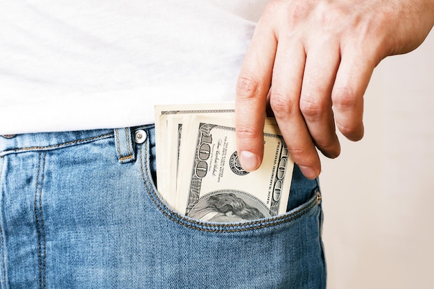 Man putting money in pocket