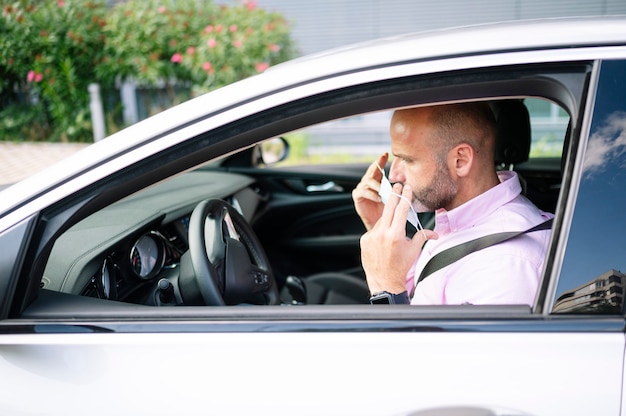 Man putting on protective mask in the car