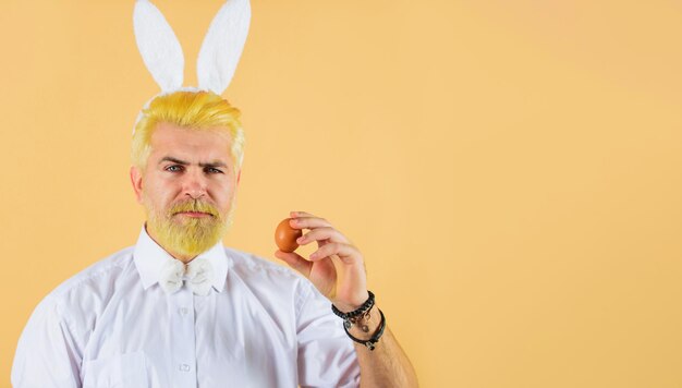 man in rabbit ears with easter egg spring holidays hunting eggs bunny guy preparing for easter