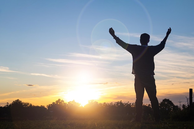 A man raises her hands with sunsethe is so calm hoperespectspiritual crucifixreligion and peacePhoto Christian and hope concept idea