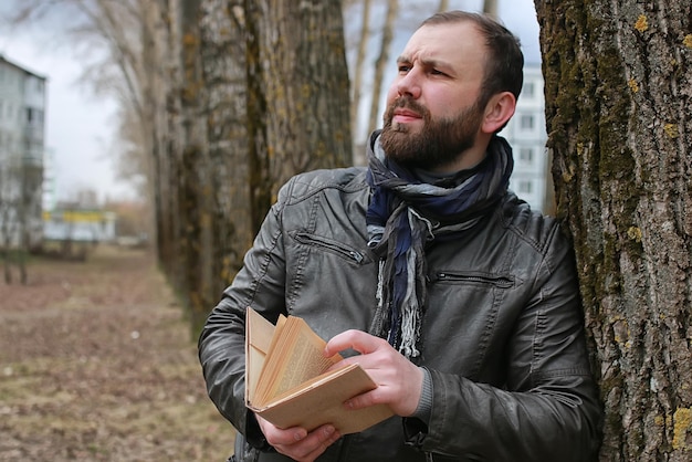 Man read book tree park