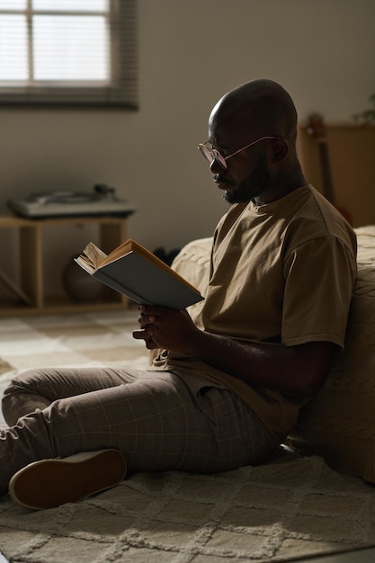 Man reading book in his bedroom