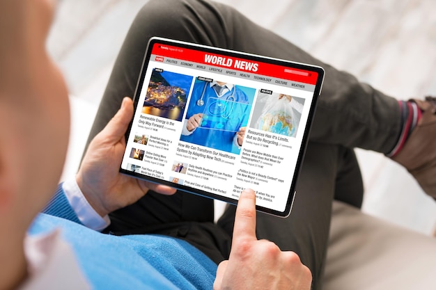 Man reading latest news on his tablet