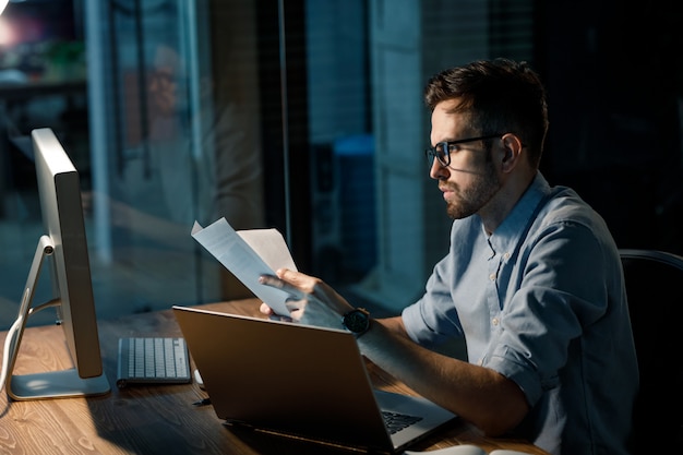 Man reading papers at workplace