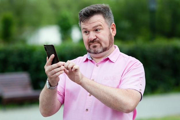 A man reads an SMS message on a smartphone. Nice social media post