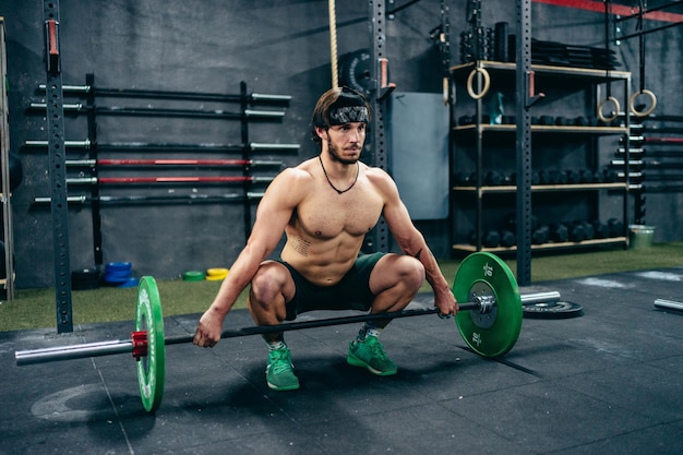 Man ready to lift weight in a gym