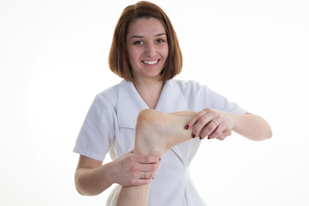 Man receiving foot reflexology by female therapist