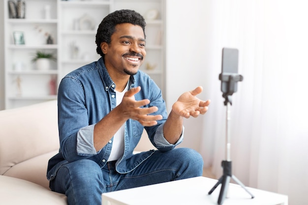 man recording a video on smartphone at home