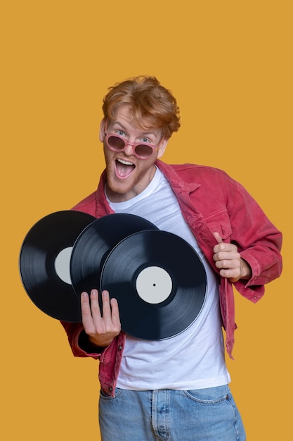 Man in red jacket with records isolated