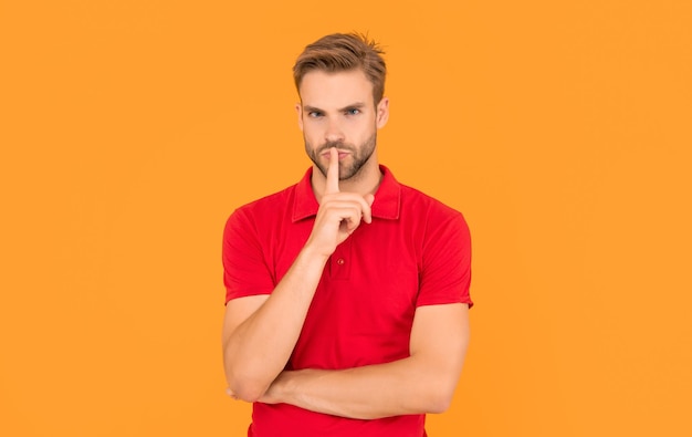 Man in red shirt keep secret on yellow background fashion