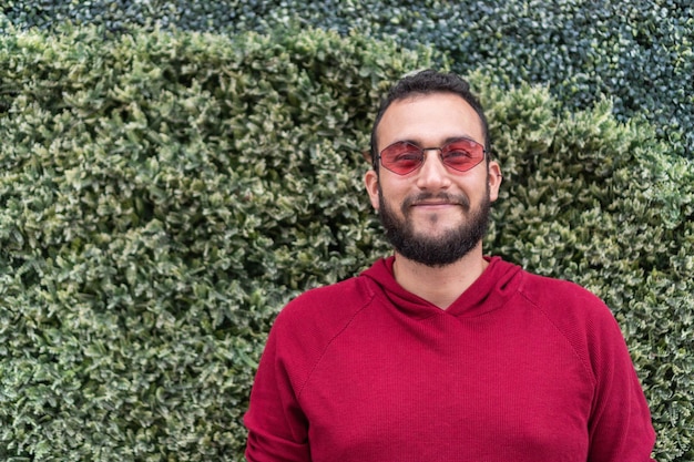 Man in red shirt smiling at the camera