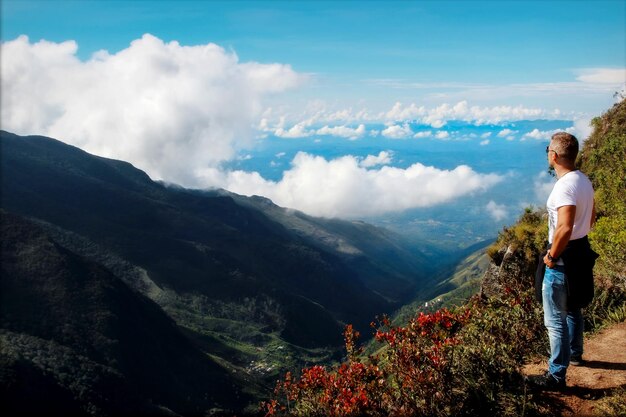 Man relaxes on the edge of the cliff  Plateau  End of the World   Sri Lanka